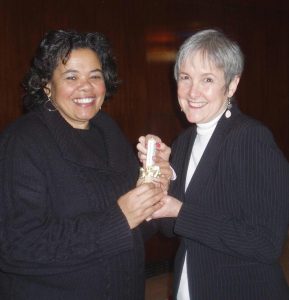 Audri Scott receives mini Peace Pole from Deborah Moldow