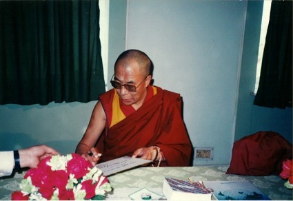 His Holiness the Dalai Lama signing May Peace Prevail On Earth, 1989
