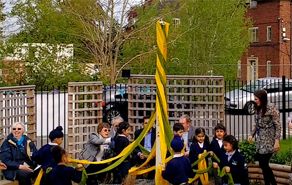 Pupils unwrap the Peace Pole at Falcons Primary School in Leicester